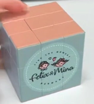 Small cube with 'felix & mina' branding on a white background-felix & mina